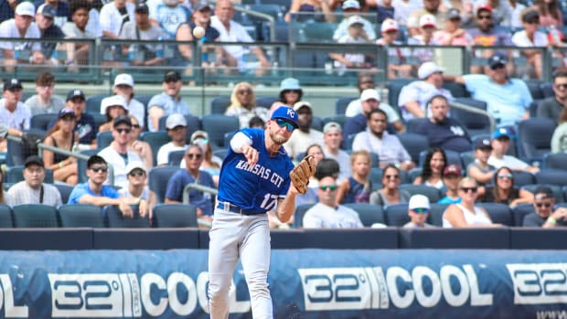 Jul 31, 2022; Bronx, New York, USA; Kansas City Royals third baseman Hunter Dozier (17) throws a runner out at first base in the fifth inning against the New York Yankees at Yankee Stadium. Mandatory Credit: Wendell Cruz-USA TODAY Sports